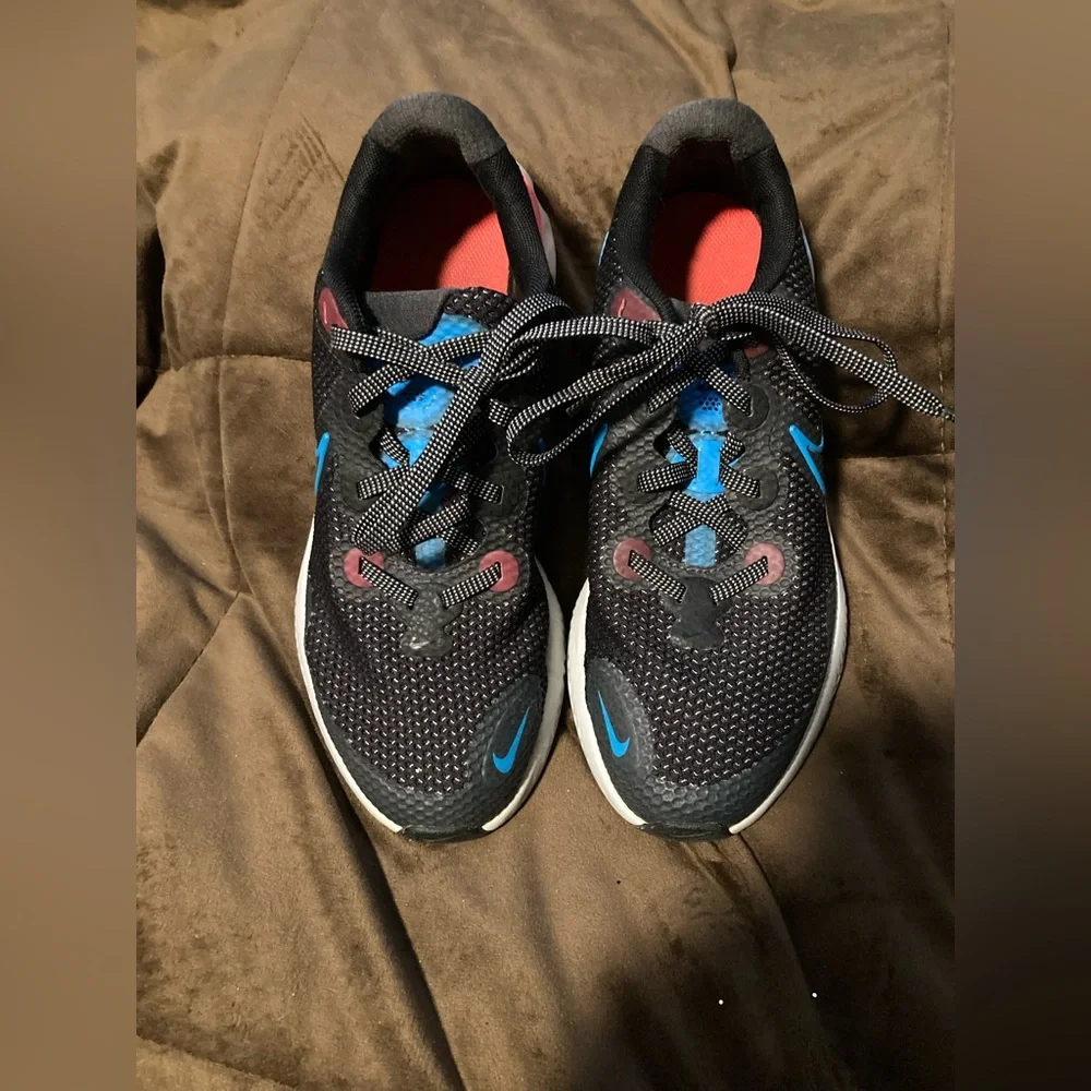 Nike brand, size 6Y, comfortable athletic shoes, black, blue and pink.